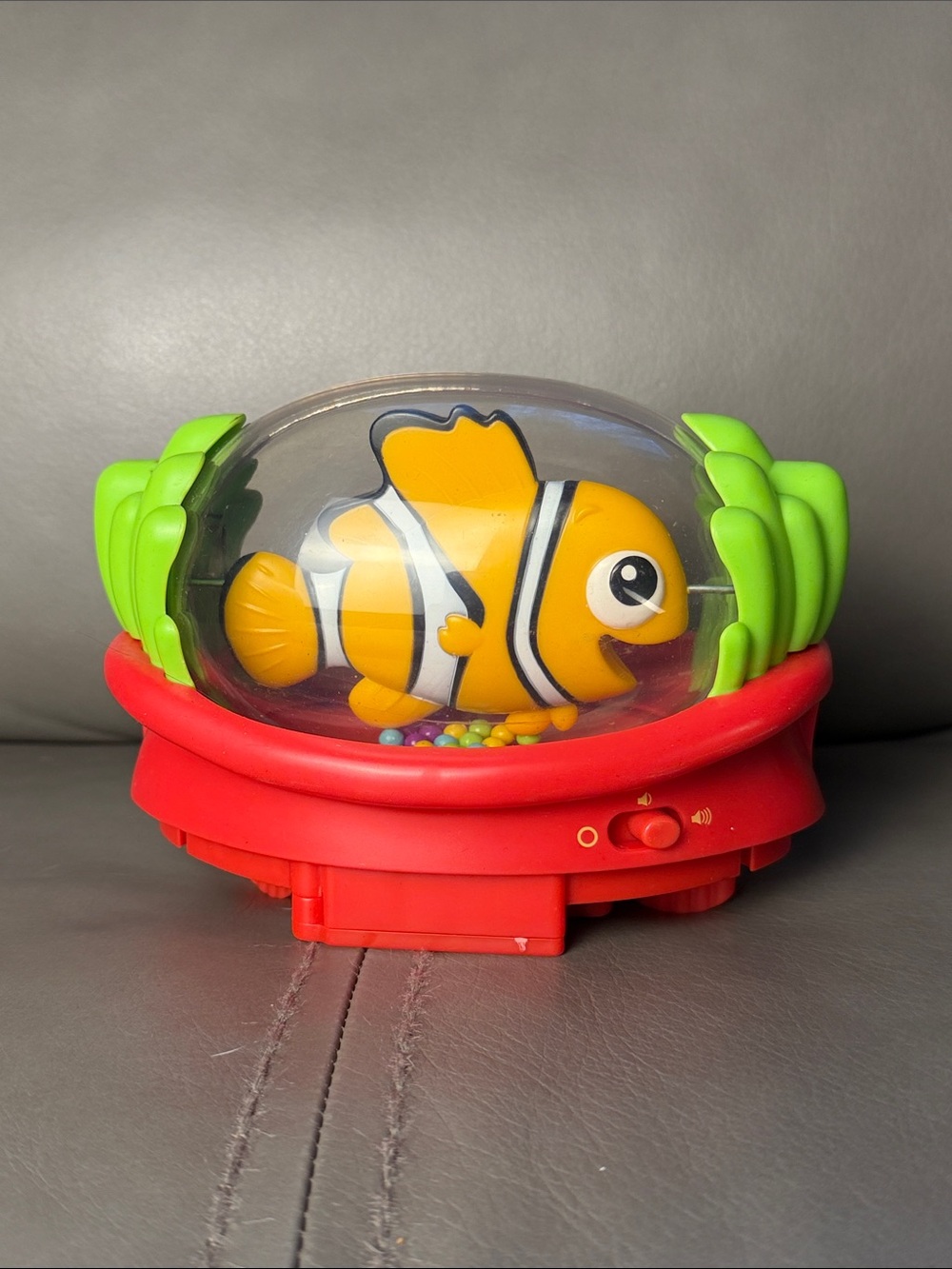 Nemo bouncer Bright Orange Fish Rattle Toy with Red Base and Green Accents